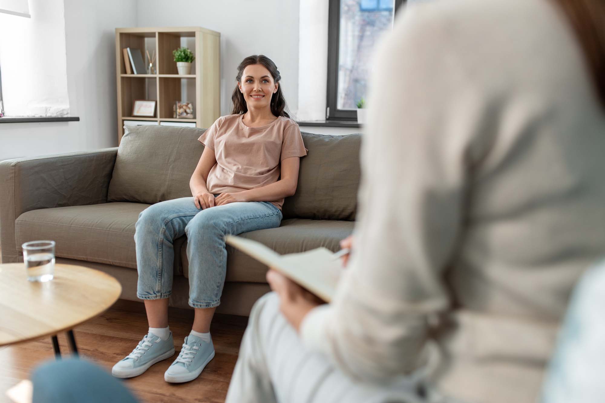 woman and psychologist at psychotherapy session