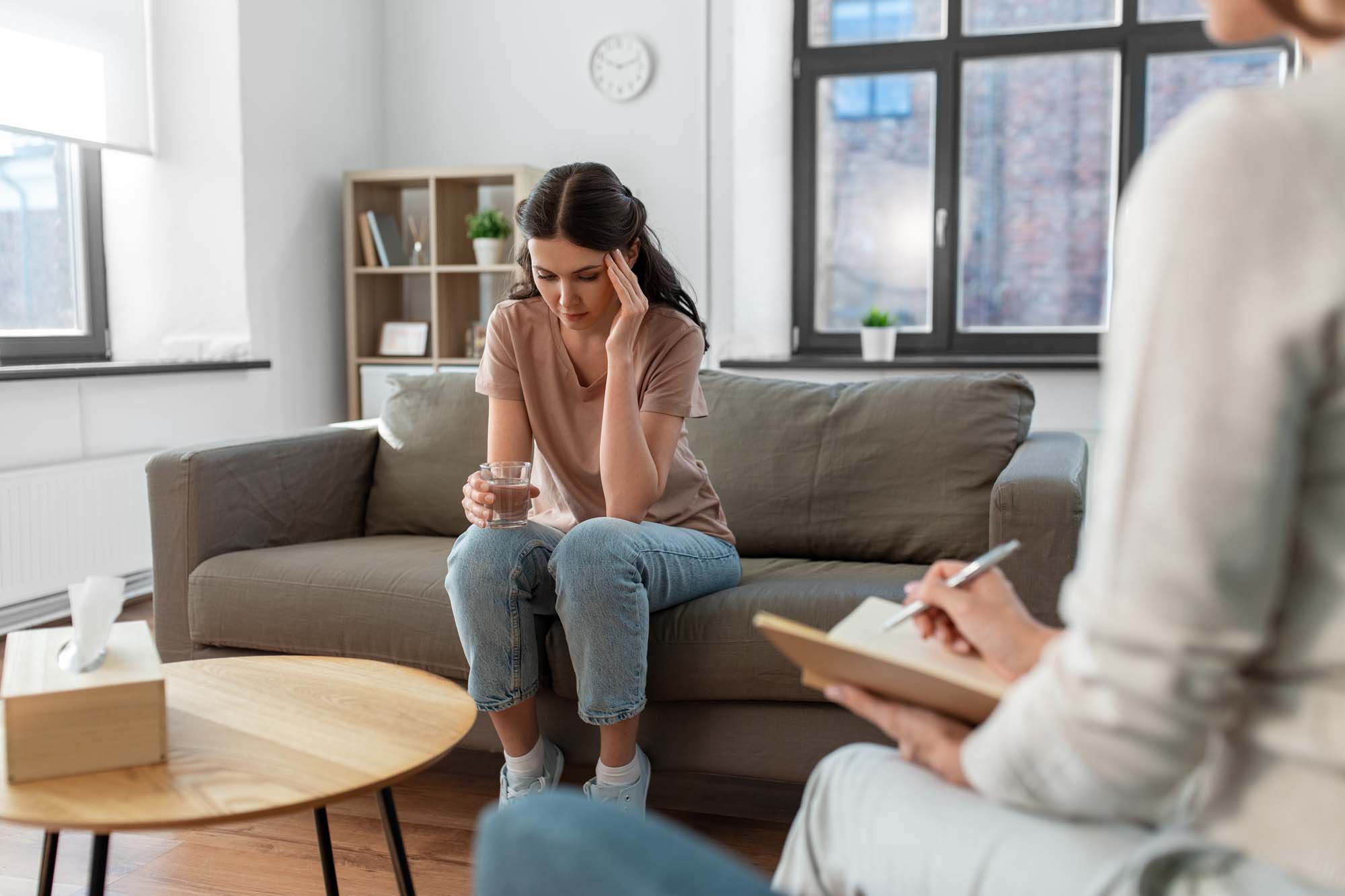 woman and psychologist at psychotherapy session