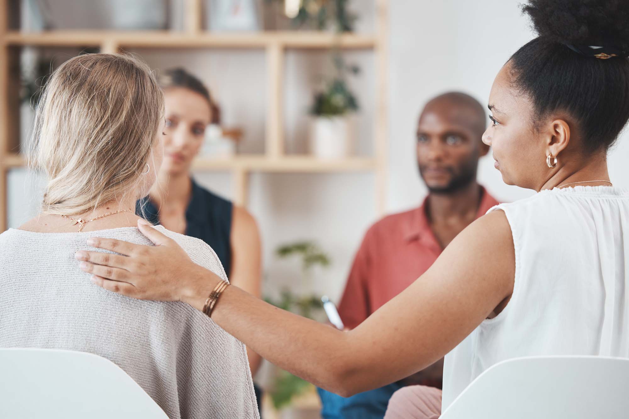 Support, help and group of people in therapy discussion for mental health problem, stress or depression with professional psychologist or therapist. Care, trust and psychology with community talking